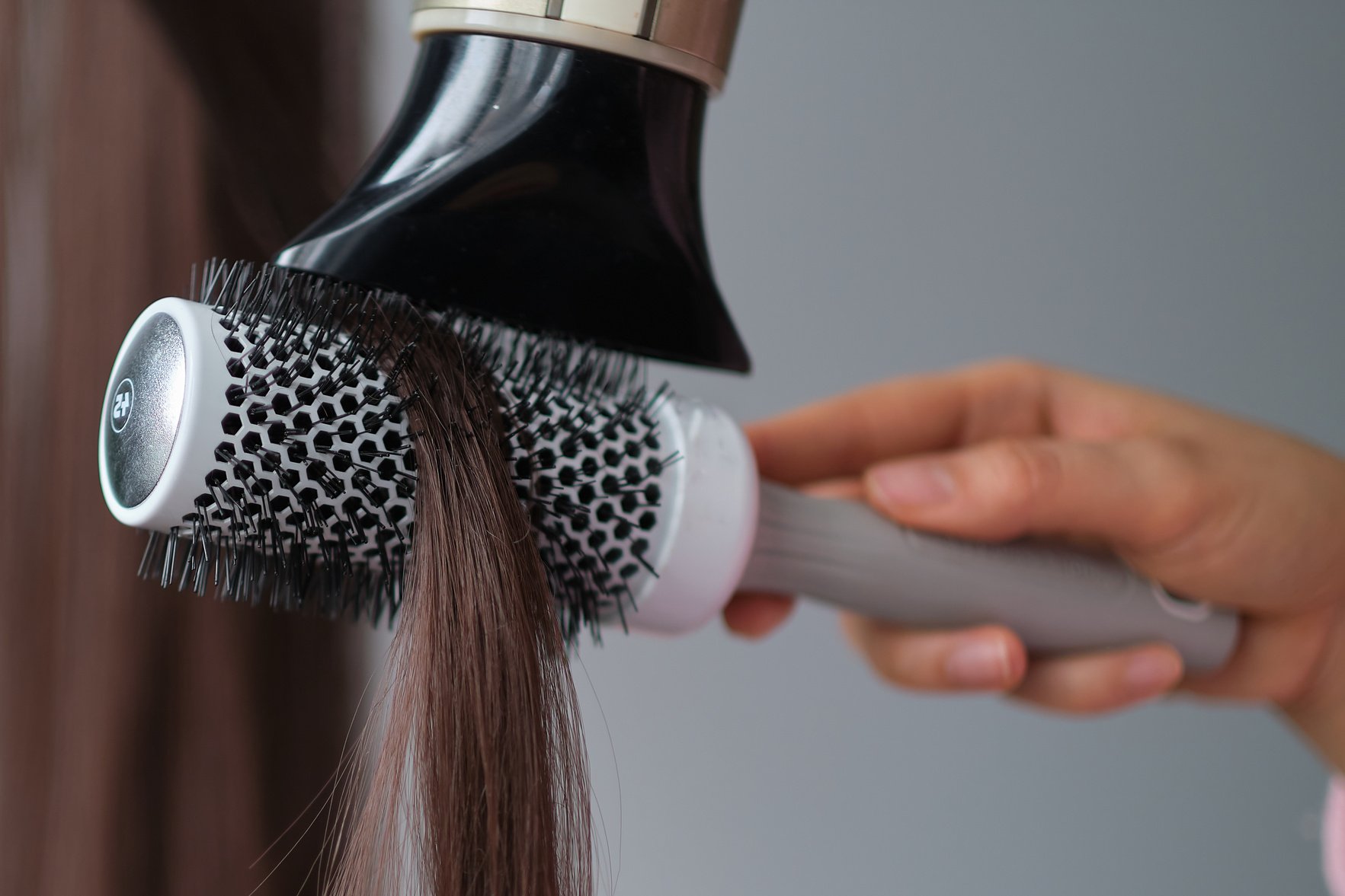 simple minimalist photo, blow dry hair styling. Close-up of hair dryer, concept cut salon, female stylist.