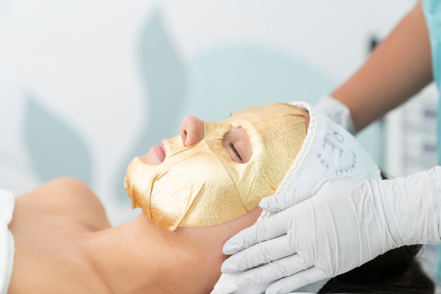 A Woman Lying Down with Gold Facial Mask on Her Face